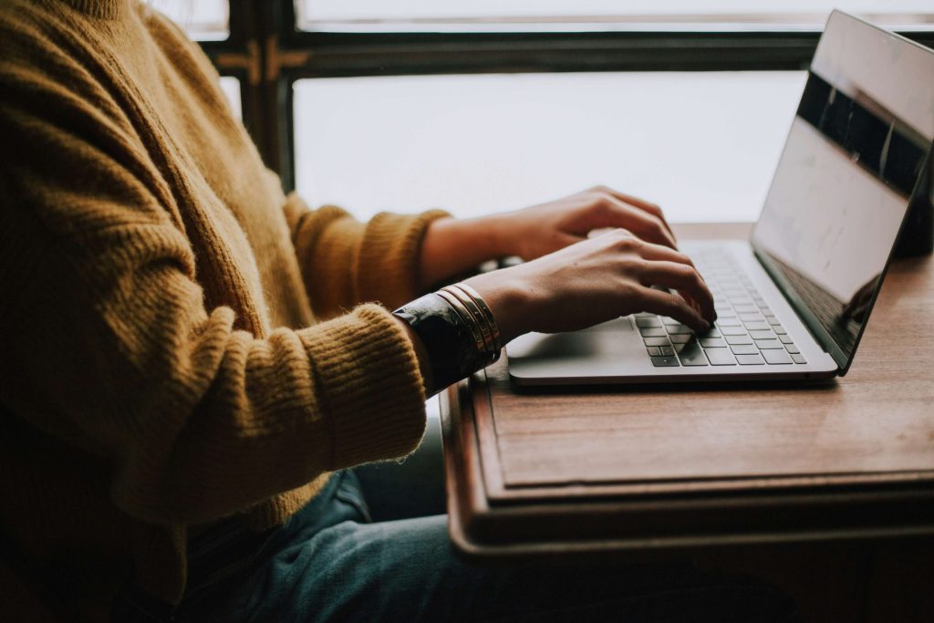 woman typing | online therapy in parkland, fl | depression counseling in parkland, fl | grief counseling | anxiety therapy | cognitive behavioral therapy | 33073 | 33067 | 33076 Image of a woman wearing a mustard color sweater sitting at a desk typing on a laptop. Work with a skilled therapist to help you overcome your symptoms with the help of online therapy in Parkland, FL.