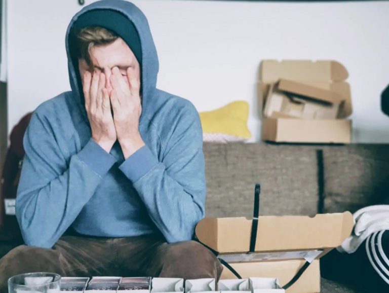 Image of an overwhelmed young man covering his face with his hands. COVID can be overwhelming, learn how therapy in Parkland, FL can help.