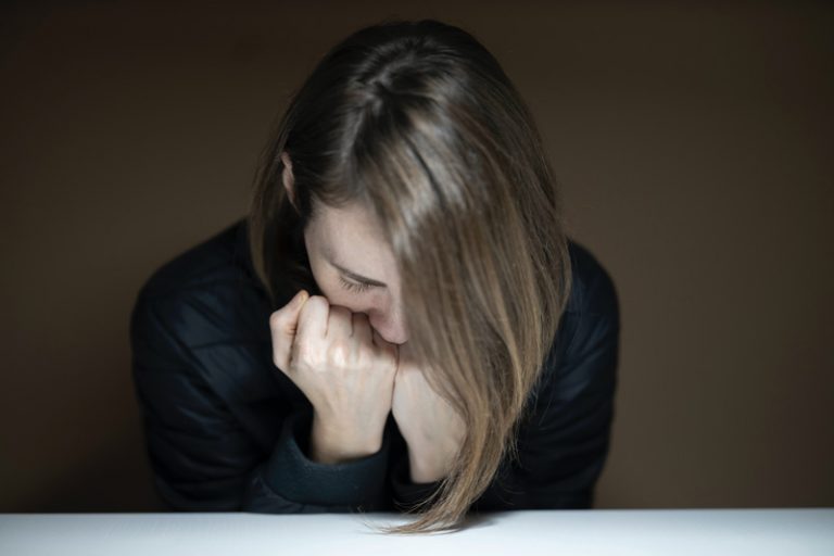 Photo of an upset woman facing downward. Are you suffering from depression? Discover the signs of depression and how depression counseling in Parkland, FL can help you manage.