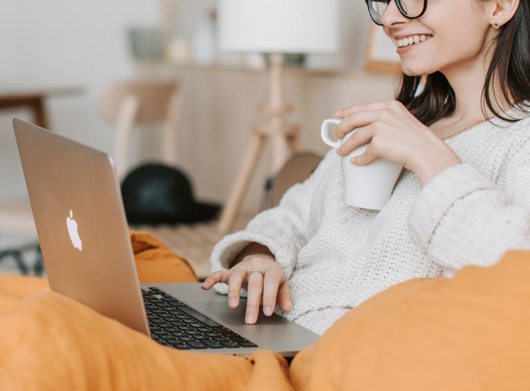 Photo of a woman wearing glasses on laptop. Wondering if Cognitive Behavioral Therapy in Coconut Creek, FL is effective online? Click here to find out!