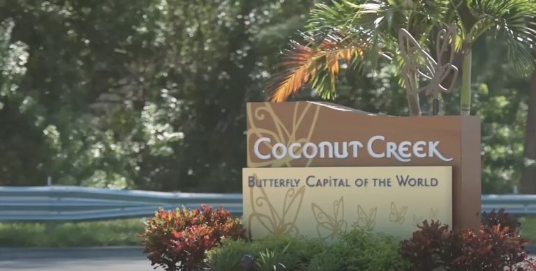Photo of a sign that says "Coconut Creek, Butterfly Capitol of the World". Learn ways you can cope with your anxiety symptoms and how anxiety therapy in Coconut Creek, FL can help you!
