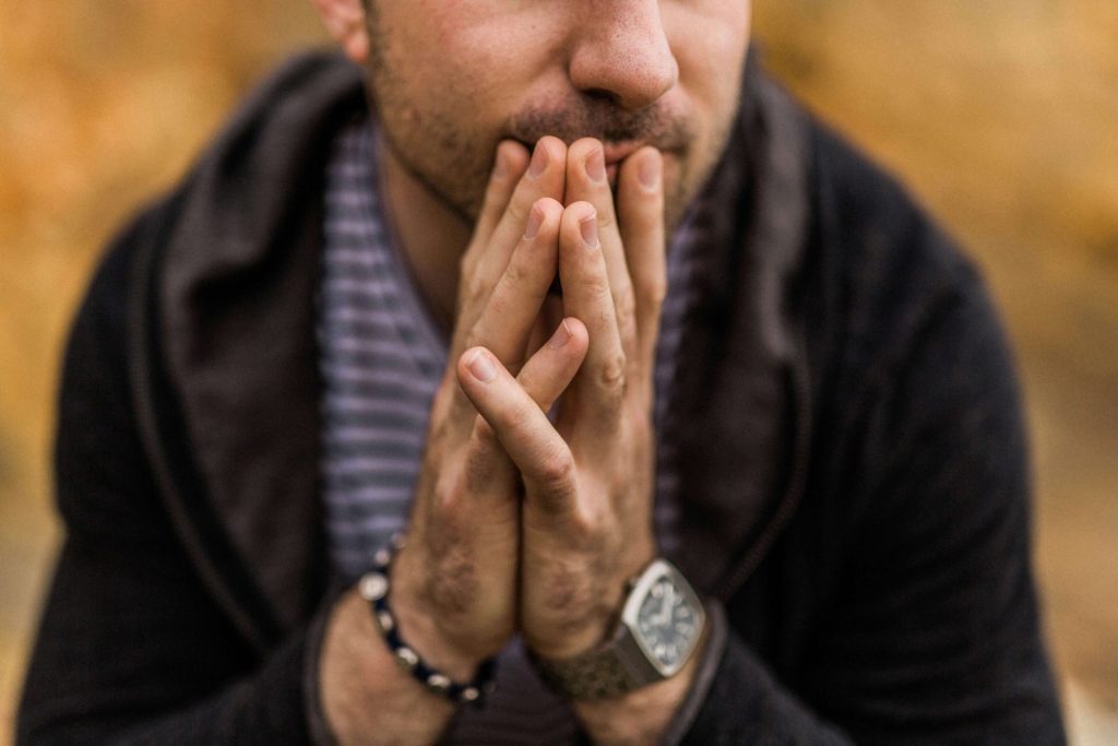 anxious man | anxiety therapy in coconut creek, fl | anxiety therapist in coconut creek, fl | anxious thoughts in parkland, fl | intrusive thoughts anxiety | anxiety therapy online florida | 33073 | 33067 | 33076 Image of an anxious man holding his hands in front of his mouth. Learn to overcome your anxious thoughts with the help of anxiety therapy in Coconut Creek, FL.