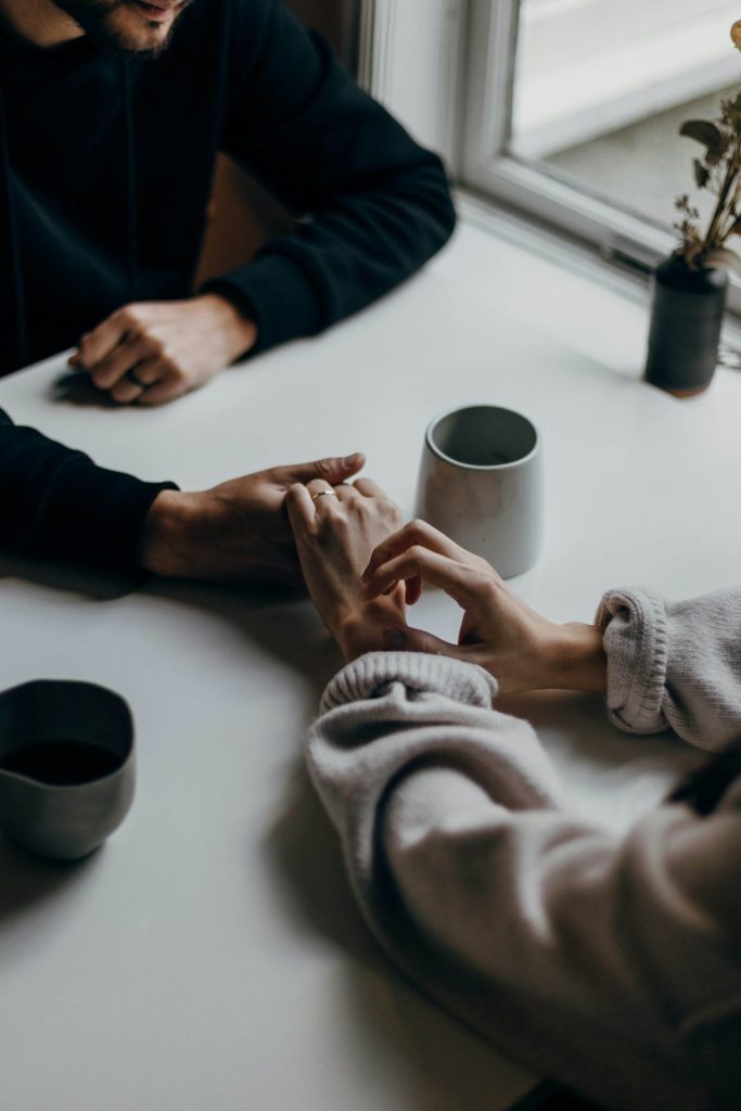 hands | depression counseling in parkland, fl | depression therapist in parkland, fl | signs of depression | depression ruining relationships | 33073 | 33067 | 33076 Image of a couple holding hands on a table with mugs. If you struggle with depression and it's affecting your relationship, learn how depression counseling in Parkland, FL can help you.