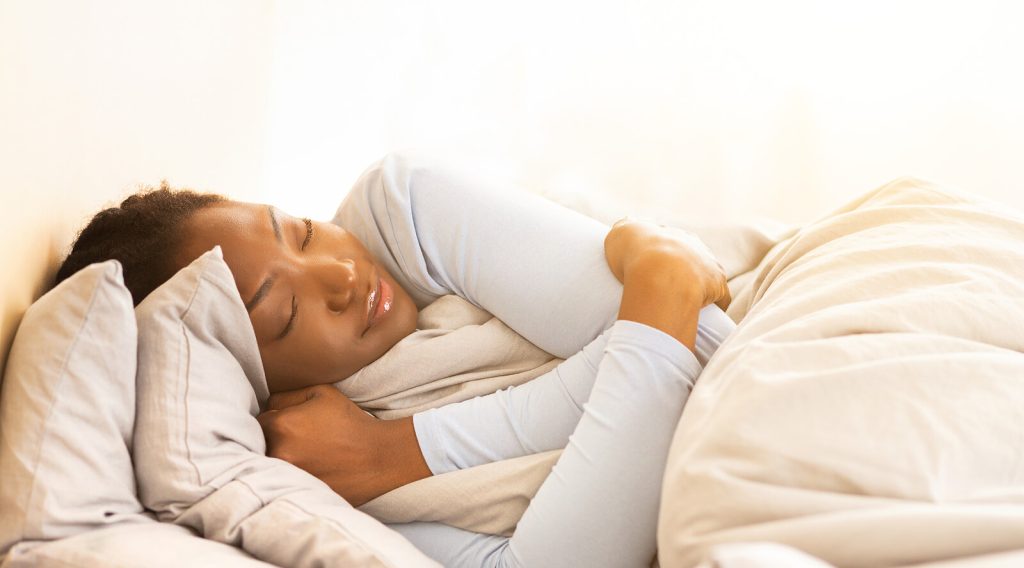 Shows a woman sleeping. Represents how anxiety treatment brickell can help you focus on self-care. Search "anxiety treatment in gainesville" today!