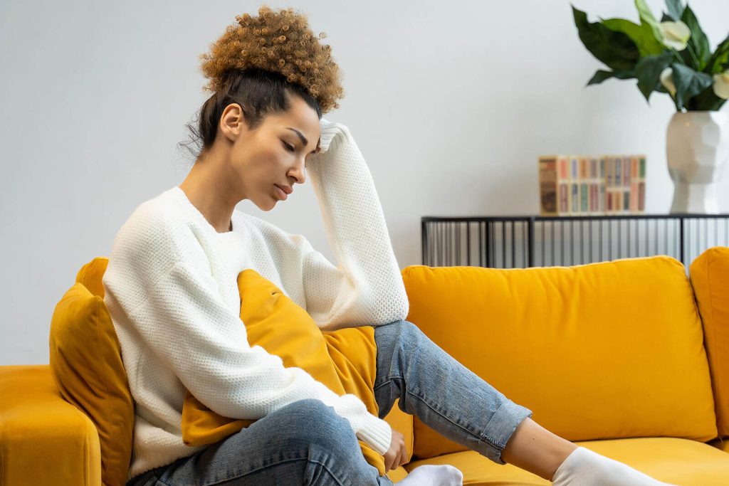 Depression | Sitting on the Couch | depression treatment program coconut creek | online therapy boca raton | depression therapist in parkland, fl | anxiety therapy Weston | delray beach psychologist | 33073 | 33067 | 33076 Shows a woman sitting on the couch. Represents how working with a depression therapist in parkland, fl can help. Search "depression treatment program coconut creek" today!
