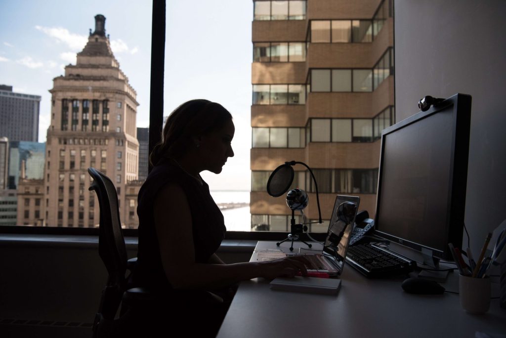 woman working | depression counseling in parkland, fl | depression therapist in parkland, fl | life transition therapy in parkland, fl | job loss depression | job loss and depression | coping with life changes and transitions | 33073 | 33067 | 33076 Image of a professional woman sitting at a desk working on a laptop in front of a window showing a city. Learn to effectively cope with your sad feelings with dealing with life transitions with the help of a depression therapist in Parkland, FL.