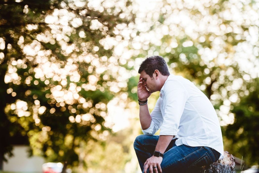 tree stump | cbt therapy in parkland, fl | depression counseling in parkland, fl | cbt for depression in parkland, fl | cbt florida | cbt therapy | cbt therapist | 33073 | 33067 | 33076 Image of a man sitting on a tree stump with his hand on his face on a sunny day. Learn effective ways, that CBT therapy in Parkland, FL can help you with your depression.