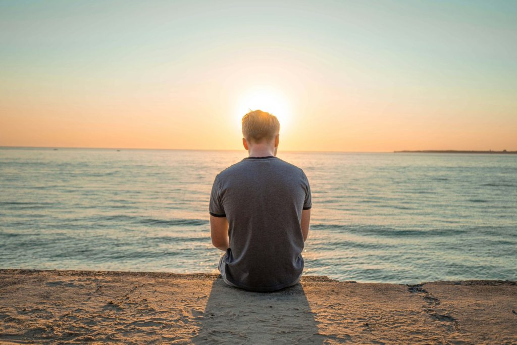 water | depression counseling in parkland, fl | depression therapist in parkland, fl | major life changes | major life changes and depression | signs of depression | 33073 | 33067 | 33076 Image of a man sitting on the ground looking at a body of water as the sun rises. Work with a skilled depression therapist to cope with your major life changes. Start depression counseling in Parkland, FL soon.