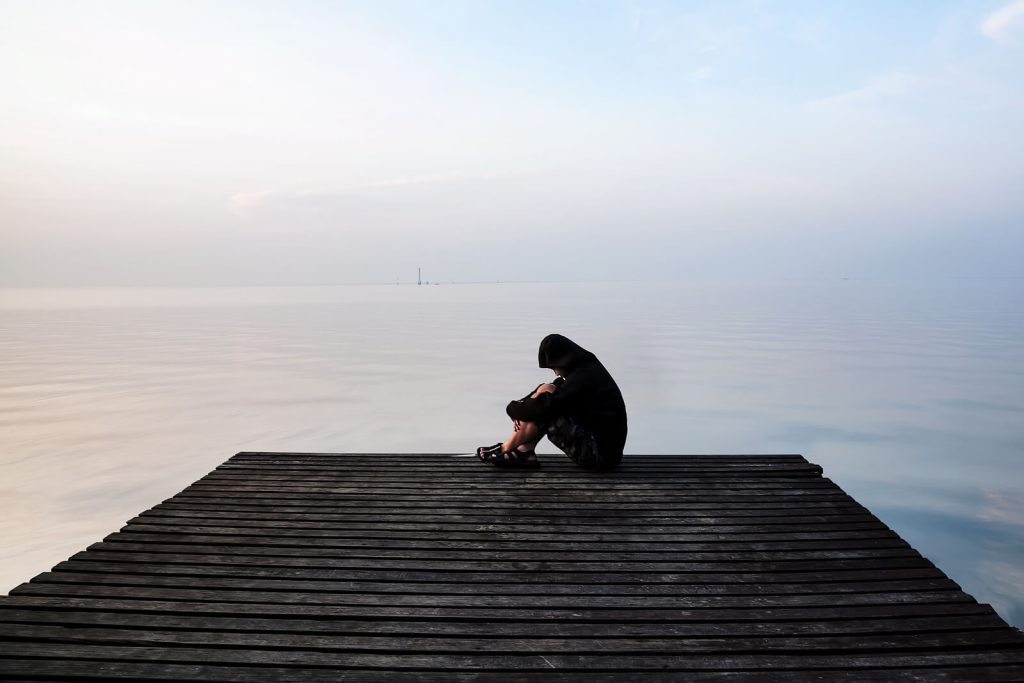 man on dock | depression counseling in parkland, fl | depression therapist in parkland, fl | high functioning depression | cbt for depression | signs of depression | 33073 | 33067 | 33076 Image of a sad man sitting at the end of a dock. If you think you may be struggling with high functioning depression, learn how depression counseling in Parkland, FL can help you cope.